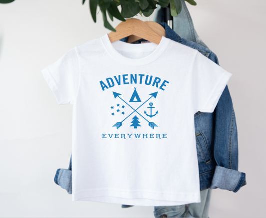 White t-shirt with blue graphic and text 'Adventure Everywhere' on a hanger with denim jacket.