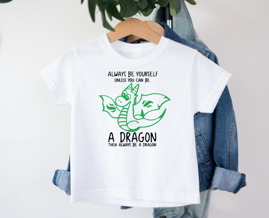White t-shirt with a dragon graphic and text on a hanger with denim jacket