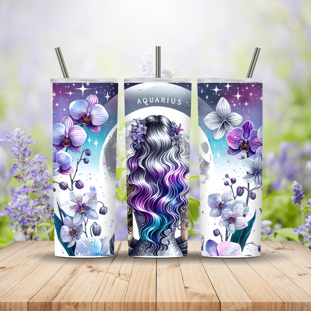 Three tumbler designs with floral and astrological themes on a wooden surface with blurred floral background.