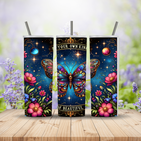 Three colorful butterfly-themed tumblers on a wooden surface with a blurred nature background.