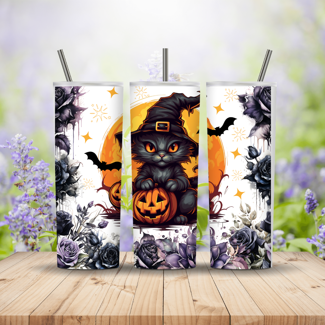 Three Halloween-themed tumblers with black cat, pumpkin, and bats design on a wooden surface with floral background.