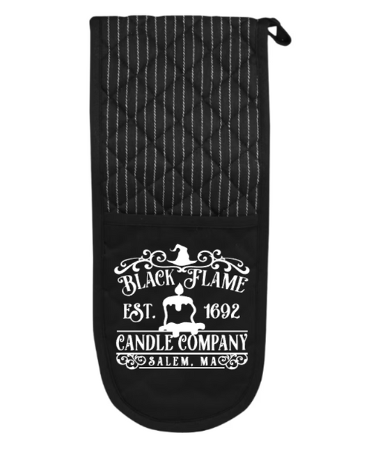 Black oven mitt with 'Black Flame Candle Company' text on a white background