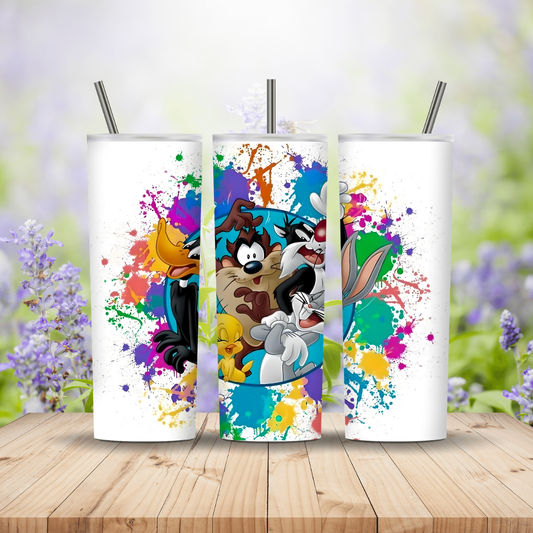 Three colourful tumblers with cartoon characters on a wooden surface with a blurred floral background. Miss Mafia