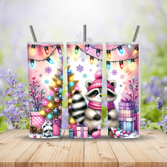 Three tumbler designs featuring a raccoon character with Christmas-themed elements on a wooden surface.