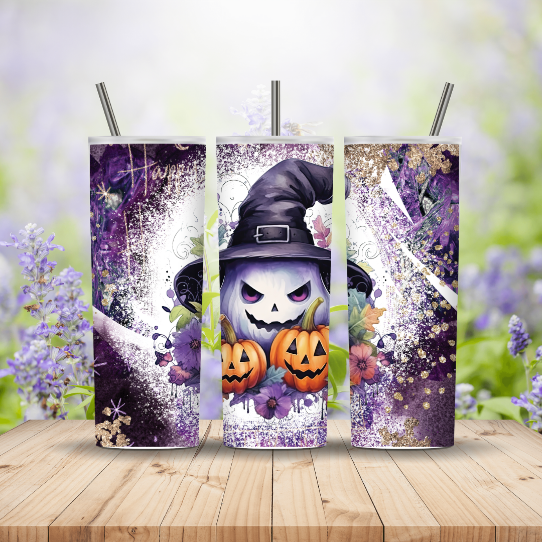 Three Halloween-themed tumblers with a witch design on a wooden surface with blurred floral background
