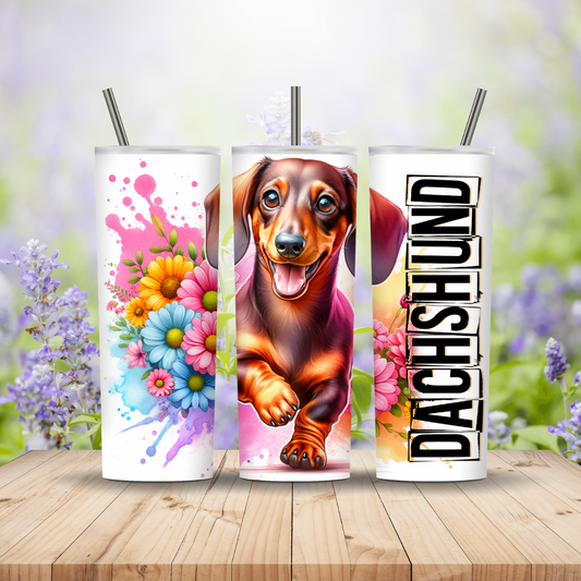 Three tumblers with floral, dachshund, and 'DACHSHUND' designs on a wooden surface with a blurred floral background. Miss Mafia