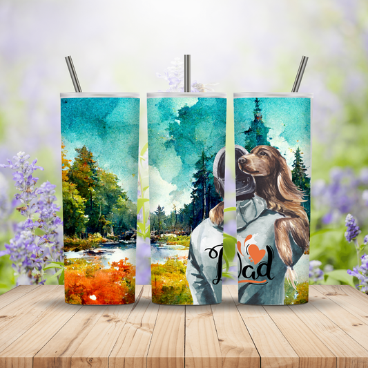 Three tumblers with nature-themed designs on a wooden surface with a blurred floral background.