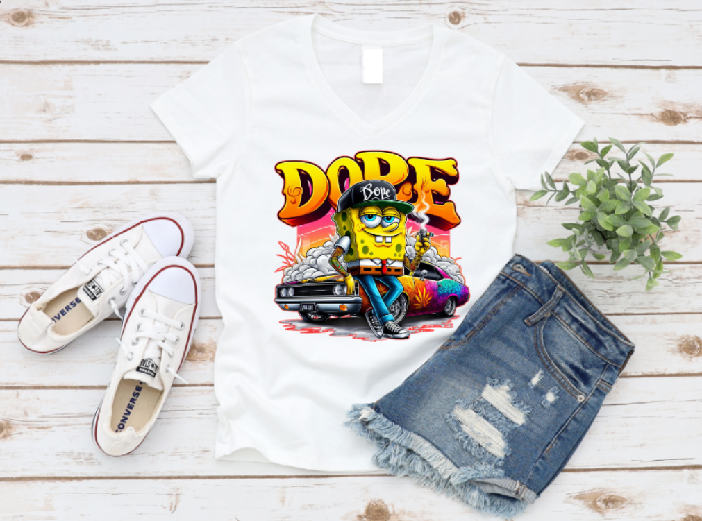 White t-shirt featuring a bold “DOPE” graffiti-style design with a cartoon street character leaning on a muscle car, surrounded by smoke and neon colours – perfect for urban fashion and hip-hop style lovers.