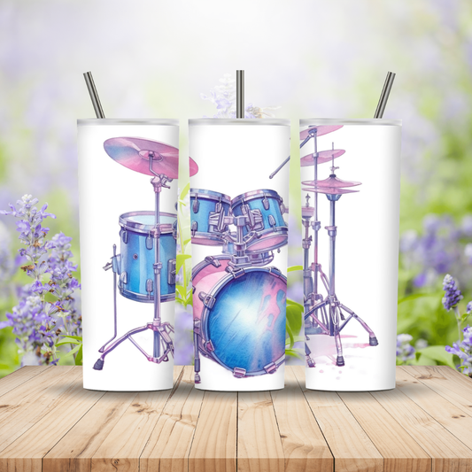 Three tumbler with drum set design on a wooden surface with blurred floral background