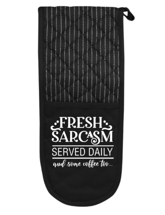 Black oven mitt with white text on a white background