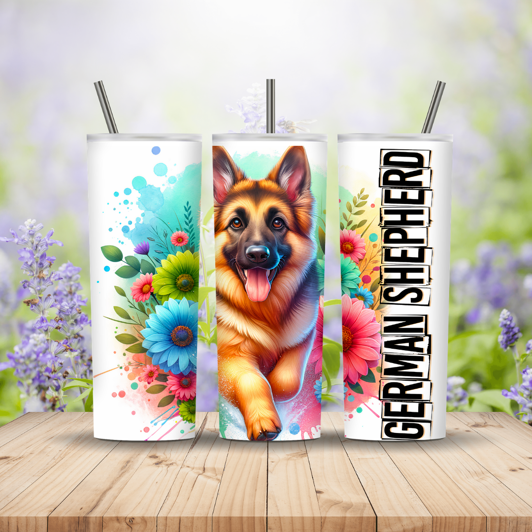 Three tumblers with a German Shepherd design on a wooden surface with a floral background.