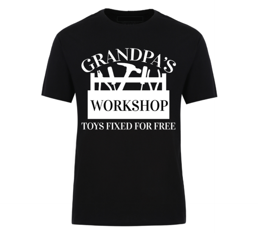 Black t-shirt with bold white text that reads “Grandpa’s Workshop – Toys Fixed for Free,” featuring tool graphics and a humorous handyman theme, perfect for grandads who love to tinker.