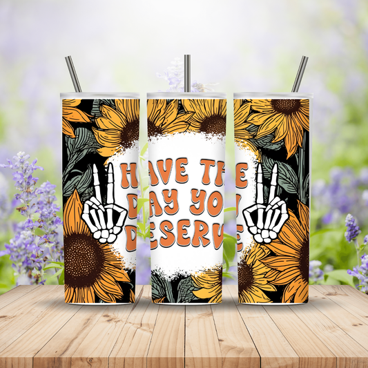 Three sunflower-themed tumblers with a message on a wooden surface with a blurred floral background.