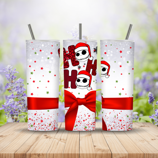 Three Christmas-themed tumblers with snowman design on a wooden surface with a blurred floral background.
