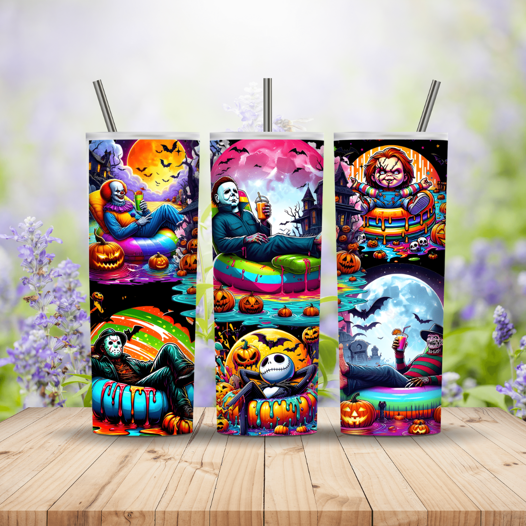Three colorful tumbler designs with Halloween-themed characters on a wooden surface.
