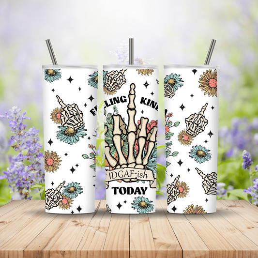 Three white tumblers with colorful designs on a wooden surface with a floral background