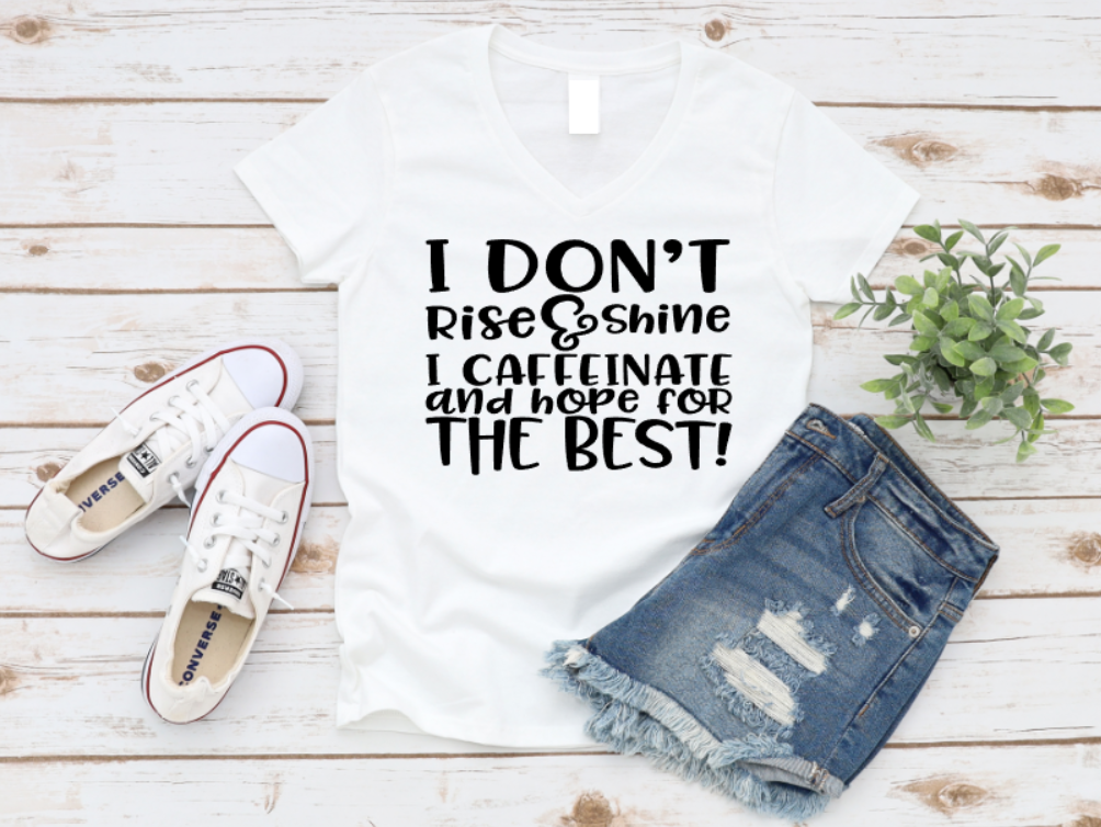 White tank top with text, white sneakers, and denim shorts on a wooden surface.