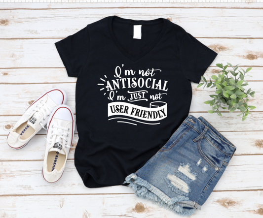 Black t-shirt with humorous text design on a wooden surface with shoes and shorts. www.missmafia.com