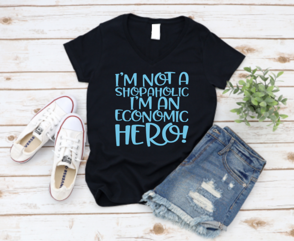 Black t-shirt with blue text on a wooden surface with shoes and shorts. www.missmafia.com