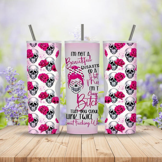 Three tumblers with skull and rose design on a wooden surface with a blurred floral background