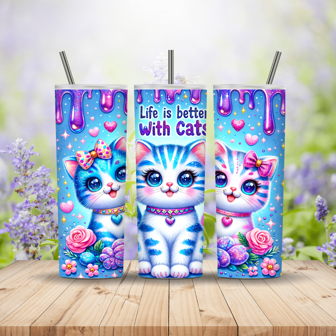 Three colorful tumblers with cartoon cats on a wooden surface with a floral background. Miss Mafia