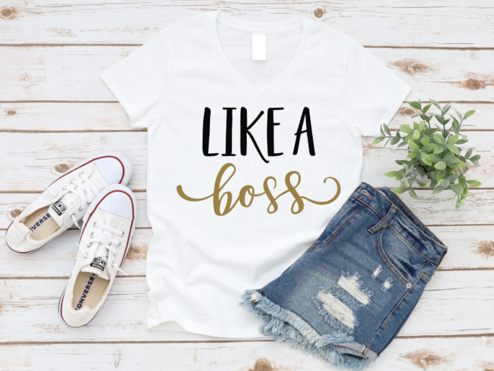 White tank top with 'LIKE A BOSS' text, white sneakers, and denim shorts on a wooden surface. www.missmafia.com