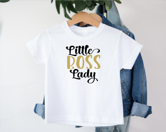 White t-shirt with 'Little Boss Lady' text on a hanger with denim jacket.