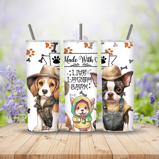 Three tumblers with dog illustrations and text on a wooden surface with a blurred floral background.  Miss Mafia