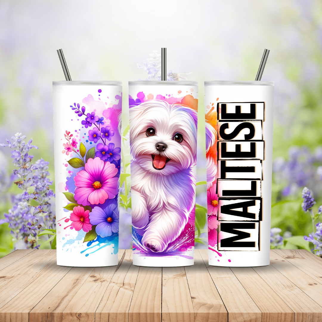 Three colorful tumblers with floral and Maltese dog designs on a wooden surface.