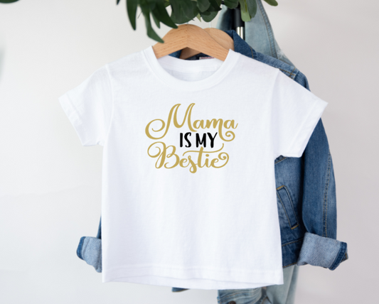 White t-shirt with 'Mama is my Bestie' text on a hanger with denim jacket.
