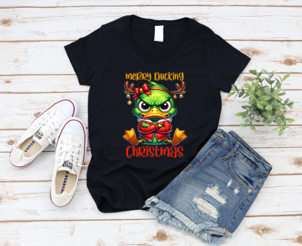 Unisex black t-shirt with “Merry Ducking Christmas” text and a grumpy cartoon duck wearing a Santa hat, designed for those who love sarcastic holiday humor.