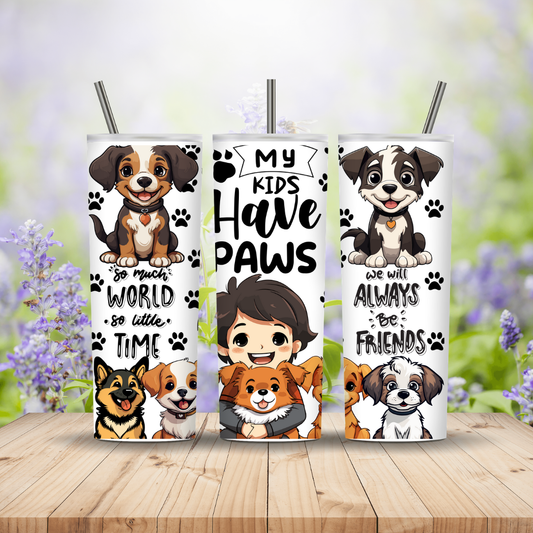 Three tumblers with dog-themed designs on a wooden surface with a blurred floral background.