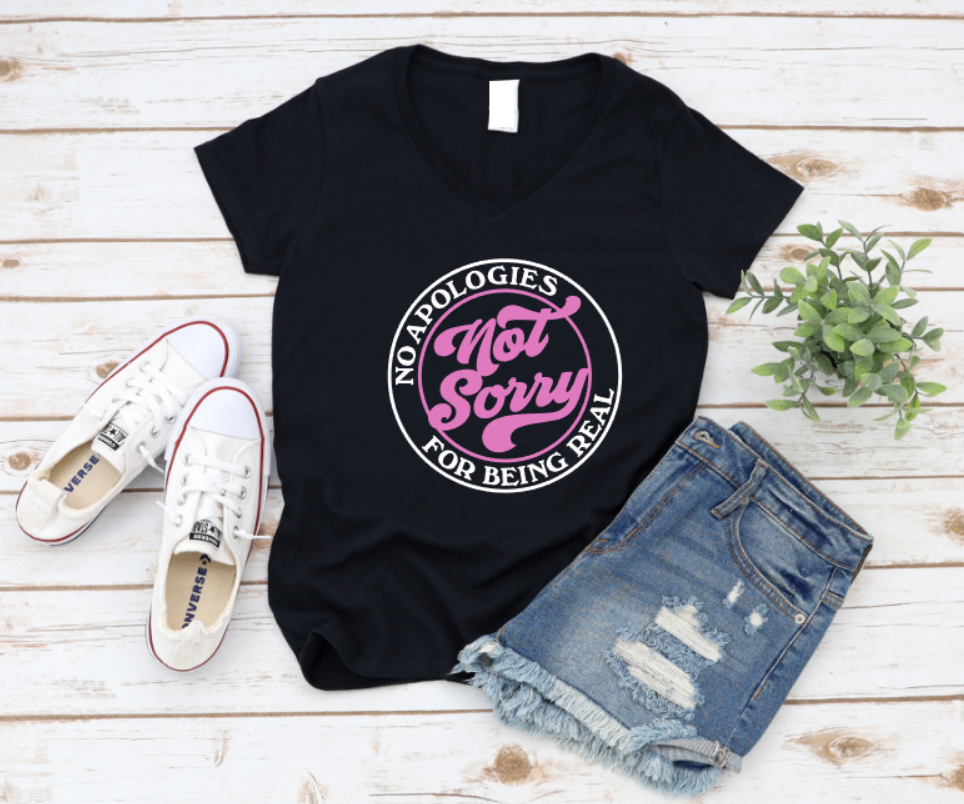 Black t-shirt with pink and white text on a wooden surface with shoes and shorts. WWW.MISSMAFIA.COM