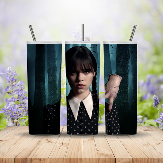Three tumblers with a design of a character from a movie or TV show on a wooden surface with a blurred floral background.