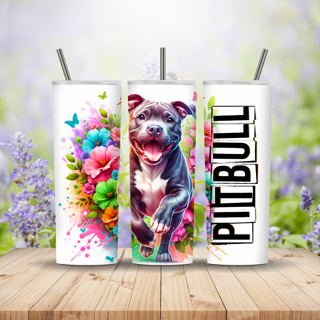 Three tumbler designs featuring a pit bull, colorful flowers, and 'PIT BULL' text on a wooden surface with a blurred floral background. Miss Mafia