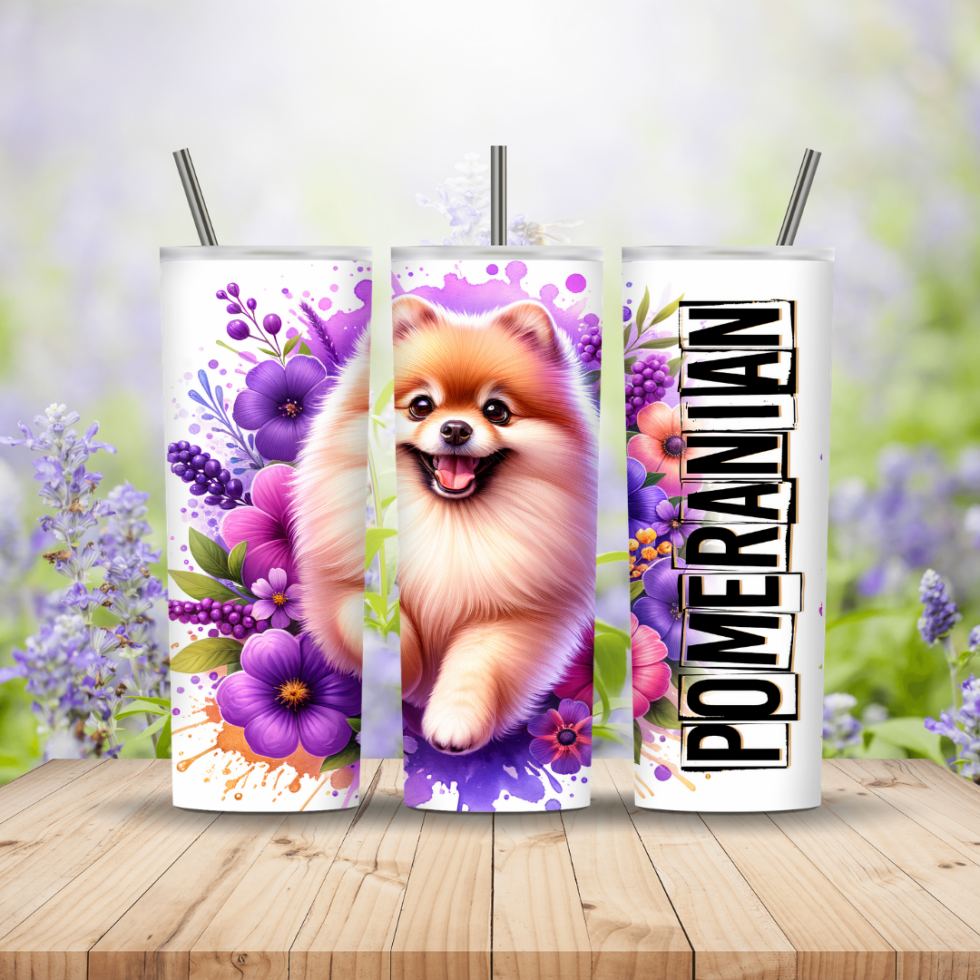 Three tumblers with Pomeranian dogs and floral designs on a wooden surface with a blurred floral background. Miss Mafia