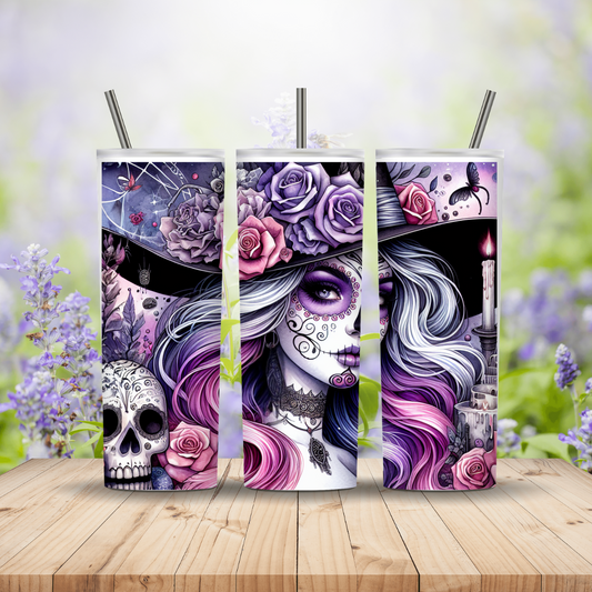 Three tumblers with a colorful design featuring a skull and roses on a wooden surface with a floral background.