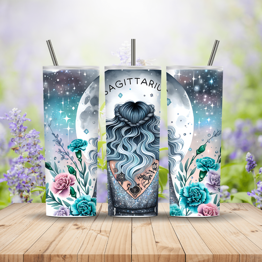 Three tumbler with straws featuring Sagittarius design on a wooden surface with flowers in the background