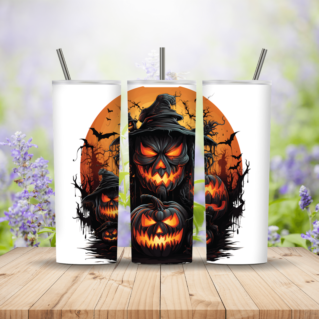 Three Halloween-themed tumblers with pumpkins and bats on a wooden surface with a blurred floral background.