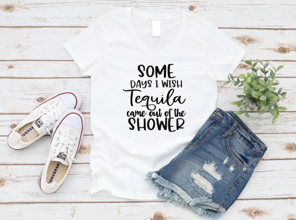 White t-shirt with humorous text, white sneakers, and denim shorts on a wooden surface. www.missmafia.com