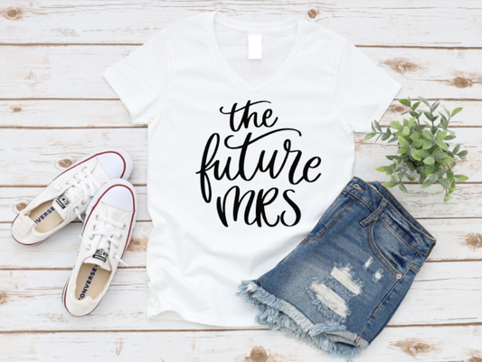 White t-shirt with 'The Future Mrs.' text, white sneakers, and denim shorts on a wooden surface.  www.missmafia.com
