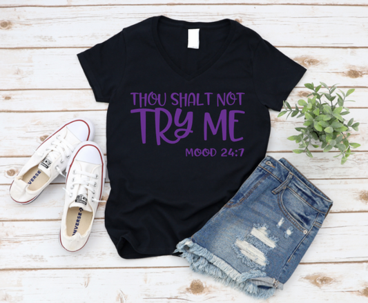 Black t-shirt with purple text, white sneakers, and denim shorts on a wooden surface.  www.missmafia.com