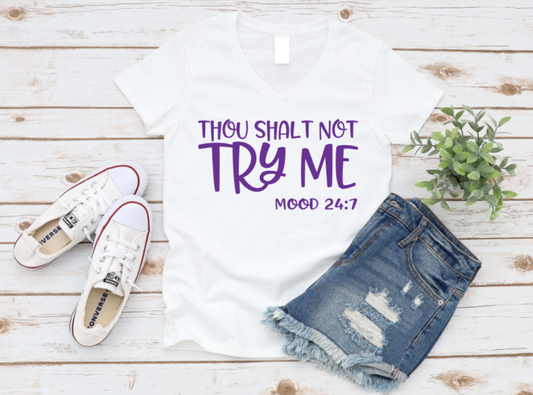 White t-shirt with 'Thou shalt not try me' text, white sneakers, and denim shorts on a wooden surface. www.missmafia.com