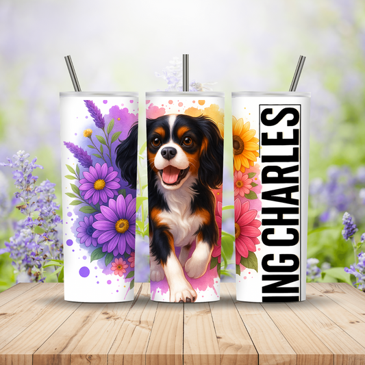 Three tumblers with a dog illustration and floral designs on a wooden surface with a blurred floral background. Miss Mafia