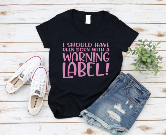 Black t-shirt with pink text, white sneakers, and denim shorts on a wooden surface. www.missmafia.com