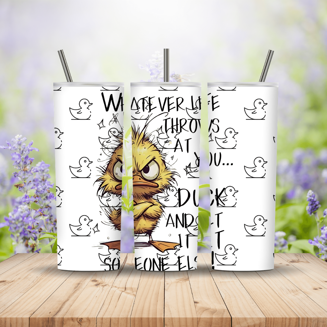 Three tumblers with a cartoon duck design and text on a wooden surface with a blurred floral background.