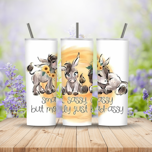 three white tumblers with images and text on a wooden background