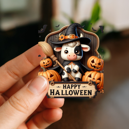 Happy Halloween cow sticker with a hand holding it
