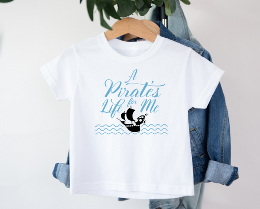 White t-shirt with 'A Pirate's Life for Me' text and ship graphic on a hanger with denim jacket.