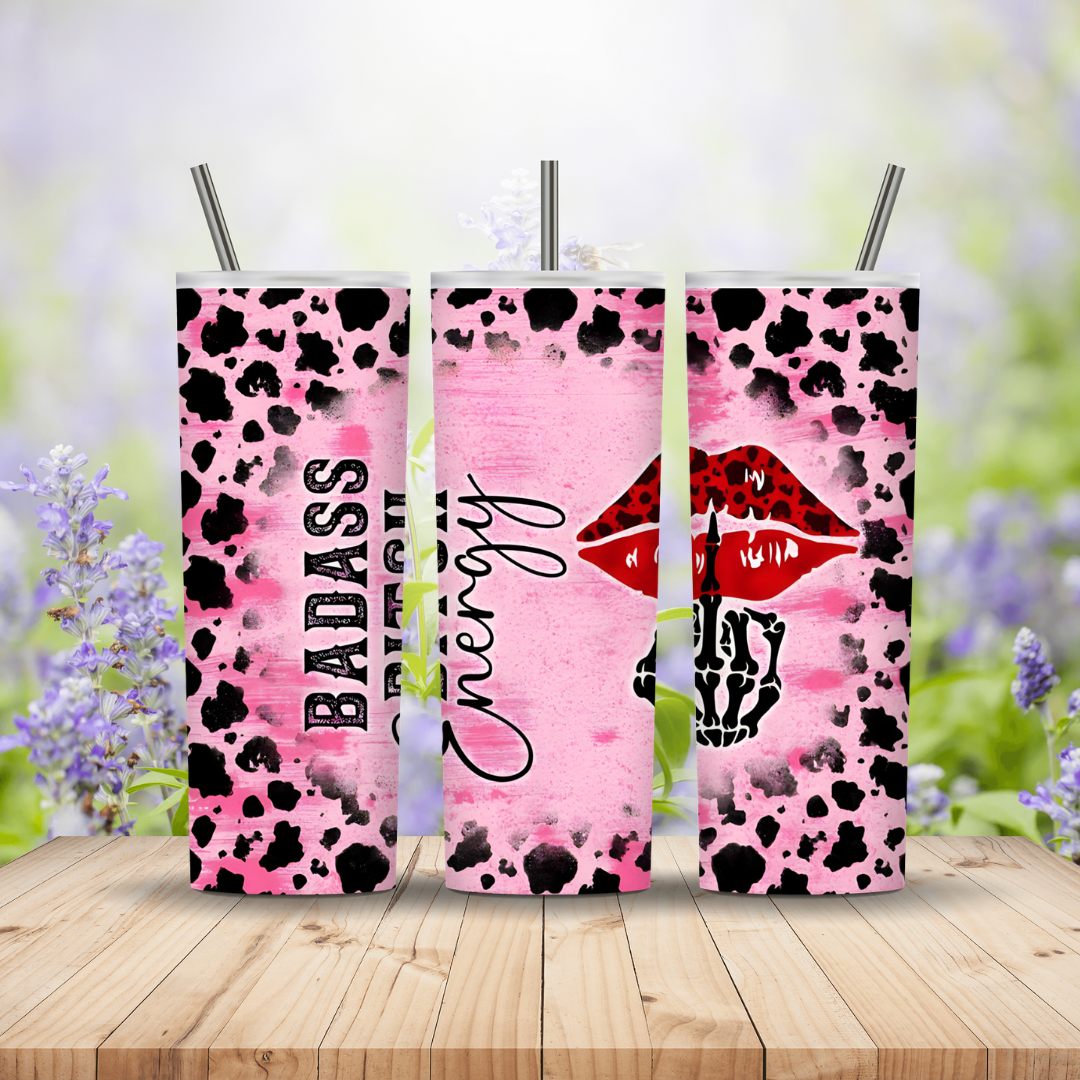 three tumblers in pink with read lips and a skeleton hand on a wooden background